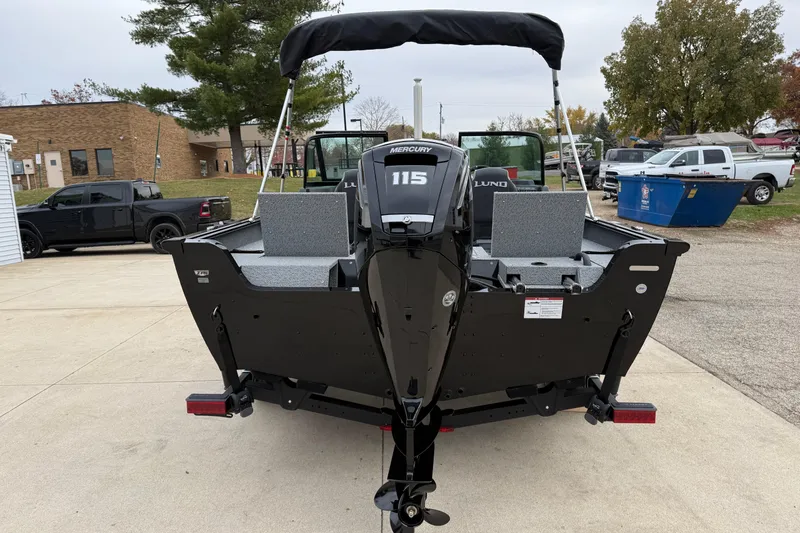 Slide: The Image of 2026 Lund 1775 Impact XS Sport boat with Mercury 115 engine, parked outdoors. - 5