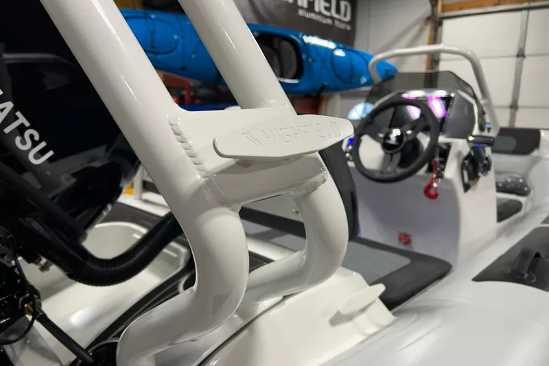 Slide: The Image of 2026 Highfield Sport 390 boat interior with steering wheel and branded details. - 17
