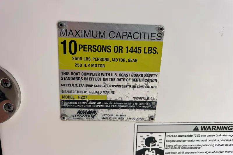 Slide: The Image of Robalo R227 Dual Console 2015 capacity plate, 10 persons or 1445 lbs, safety compliance. - 15