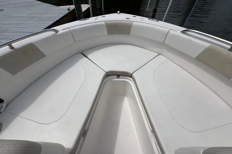 Slide: The Image of 2015 Robalo R227 Dual Console boat interior with white cushioned seating. - 19