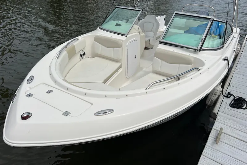 Slide: The Image of 2015 Robalo R227 Dual Console boat docked, featuring spacious seating and sleek design. - 2