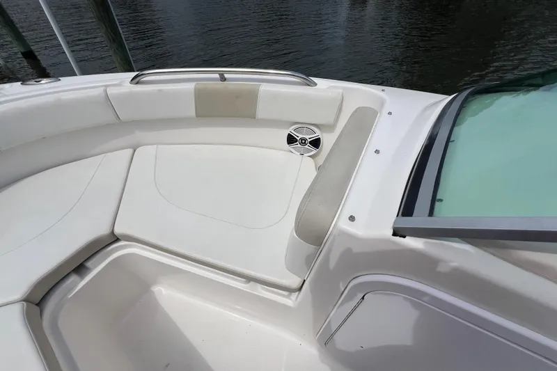 Slide: The Image of 2015 Robalo R227 Dual Console boat interior with cushioned seating and speaker. - 20