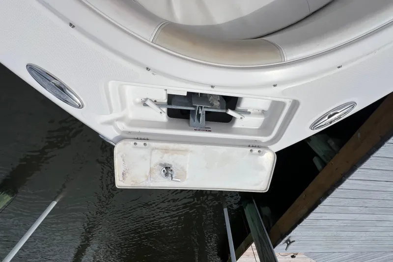 Slide: The Image of 2015 Robalo R227 Dual Console boat anchor compartment, docked by water. - 21