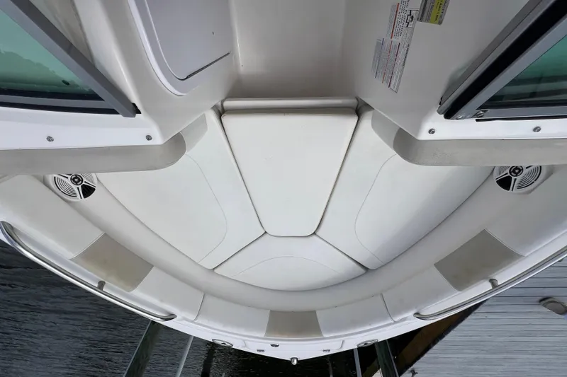 Slide: The Image of 2015 Robalo R227 Dual Console boat interior with white seating and speakers. - 24