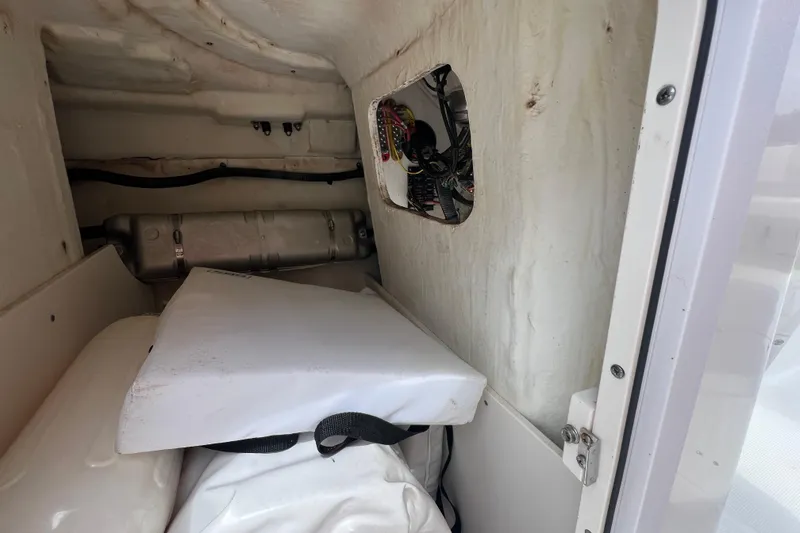 Slide: The Image of Interior view of a 2015 Robalo R227 Dual Console boat storage compartment. - 26