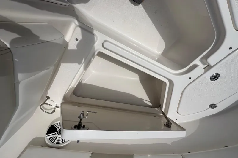 Slide: The Image of 2015 Robalo R227 Dual Console boat interior storage compartment with open hatch. - 29