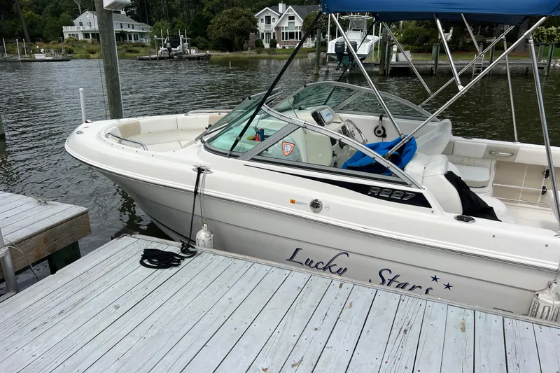 Slide: The Image of 2015 Robalo R227 Dual Console boat docked by a wooden pier. - 3
