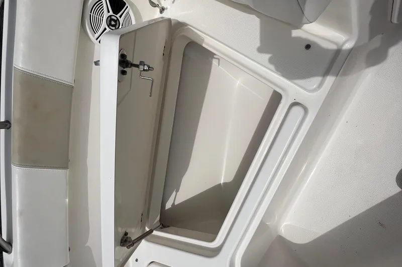 Slide: The Image of Open storage compartment on 2015 Robalo R227 Dual Console boat interior. - 30