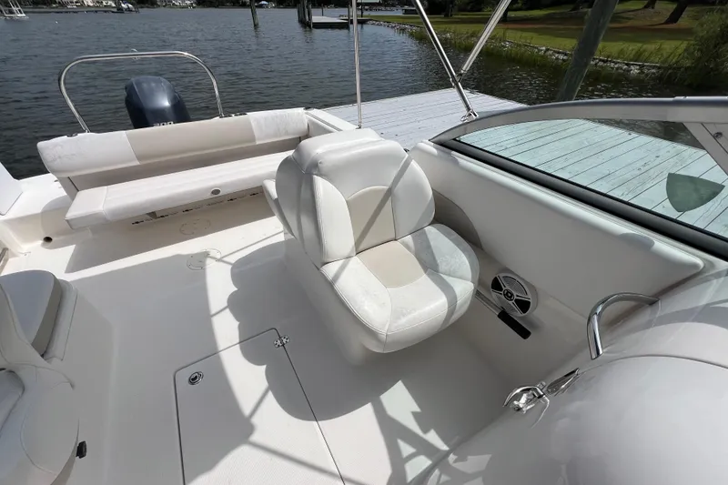 Slide: The Image of 2015 Robalo R227 Dual Console boat interior with white seating and water view. - 33