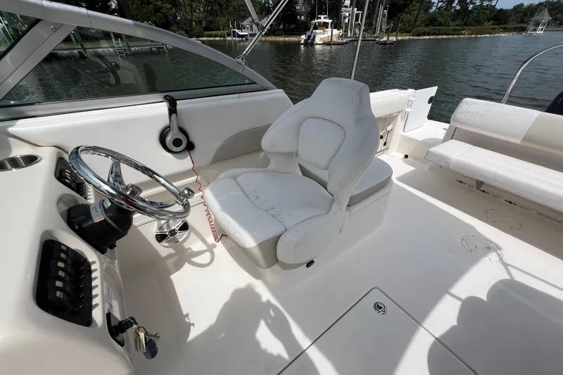 Slide: The Image of 2015 Robalo R227 Dual Console boat interior with steering wheel and seating. - 35