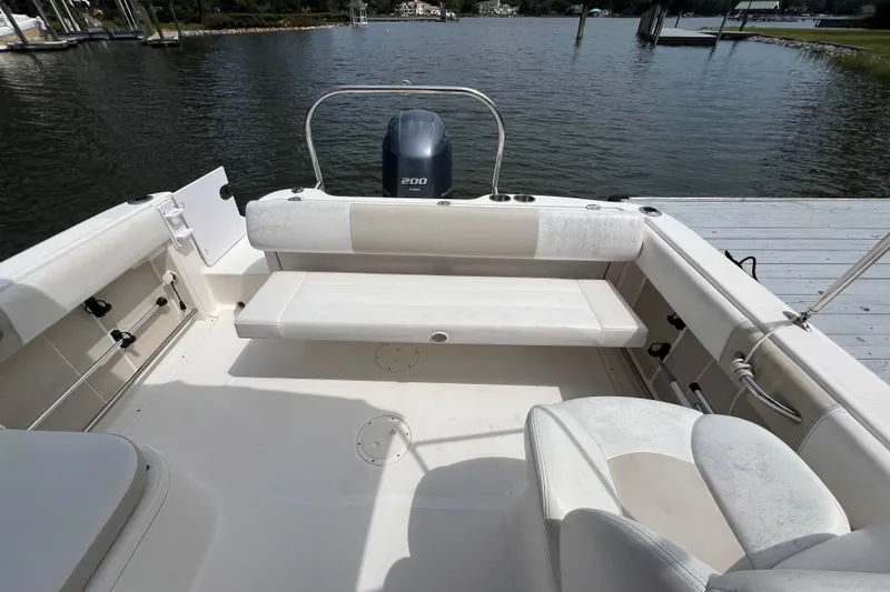 Slide: The Image of 2015 Robalo R227 Dual Console boat interior with seating and outboard motor. - 37