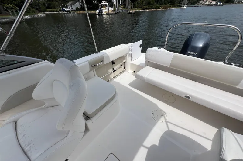 Slide: The Image of 2015 Robalo R227 Dual Console boat interior with seating and outboard motor. - 38