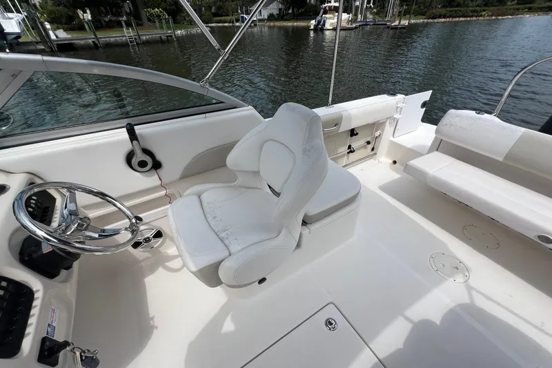 Slide: The Image of 2015 Robalo R227 Dual Console boat interior with steering wheel and seating. - 39