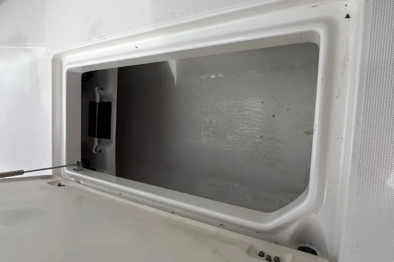 Slide: The Image of 2015 Robalo R227 Dual Console storage compartment, open and empty. - 40