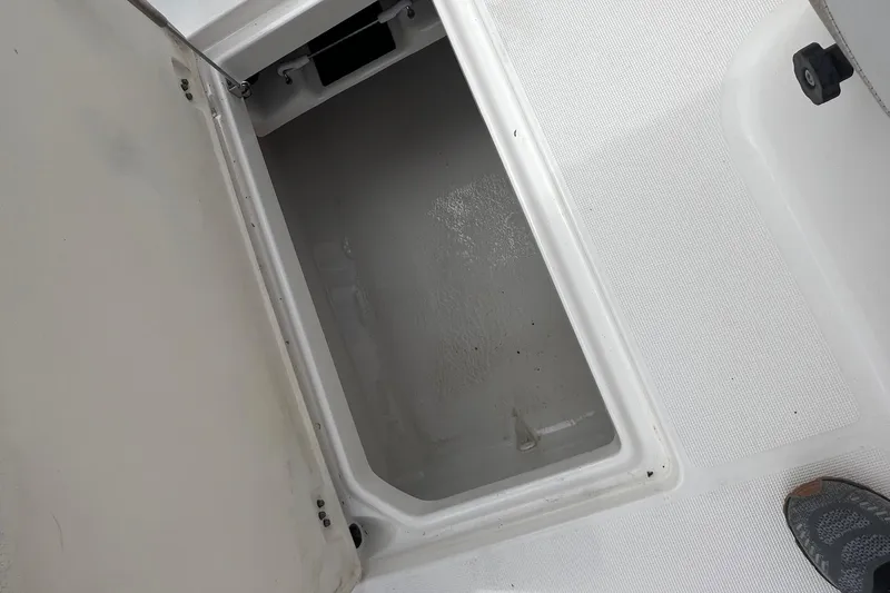 Slide: The Image of Open storage compartment on a 2015 Robalo R227 Dual Console boat. - 41