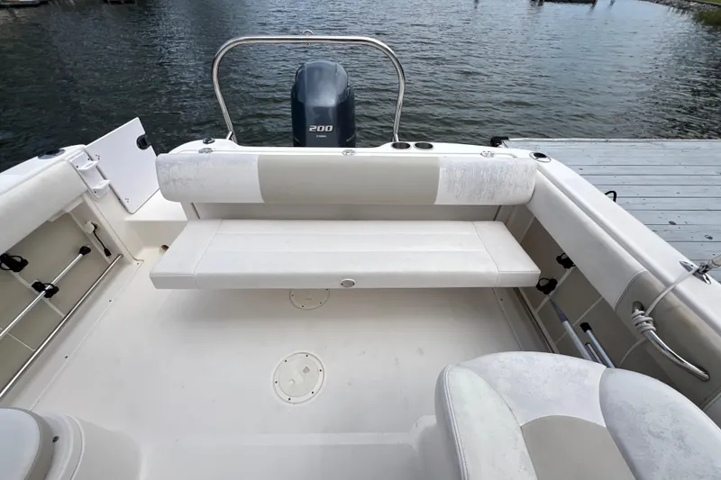 Slide: The Image of 2015 Robalo R227 Dual Console boat interior with seating and Yamaha 200 engine. - 42