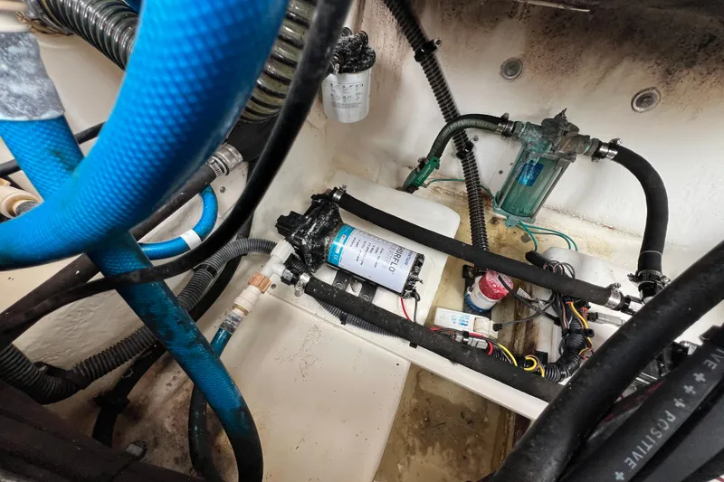 Slide: The Image of 2015 Robalo R227 Dual Console boat engine compartment with hoses and wiring. - 45