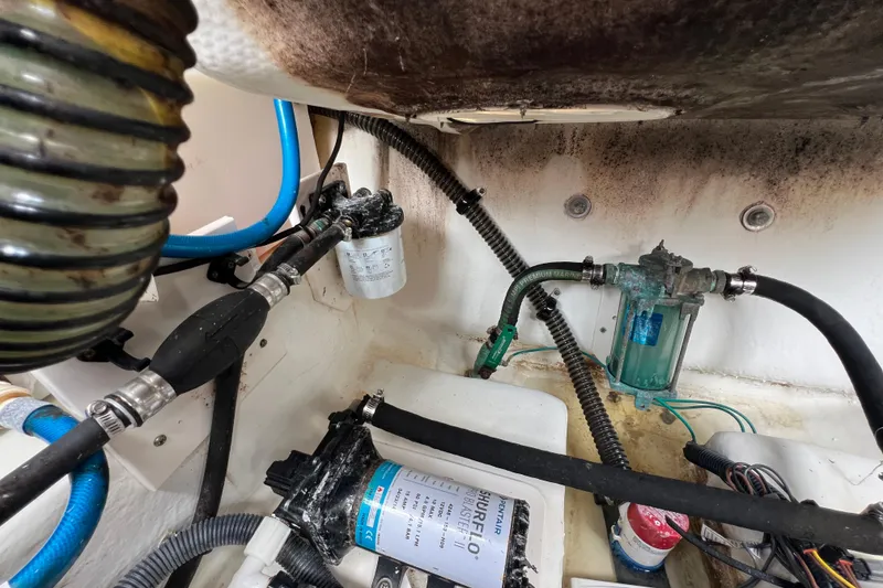 Slide: The Image of Engine compartment of 2015 Robalo R227 Dual Console with fuel and water filtration systems. - 47