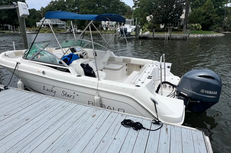 Slide: The Image of 2015 Robalo R227 Dual Console boat docked with Yamaha outboard motor. - 5