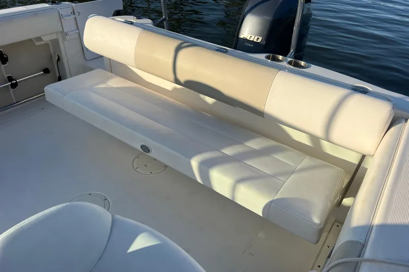 Slide: The Image of 2015 Robalo R227 Dual Console boat interior with beige seating and Yamaha engine. - 53