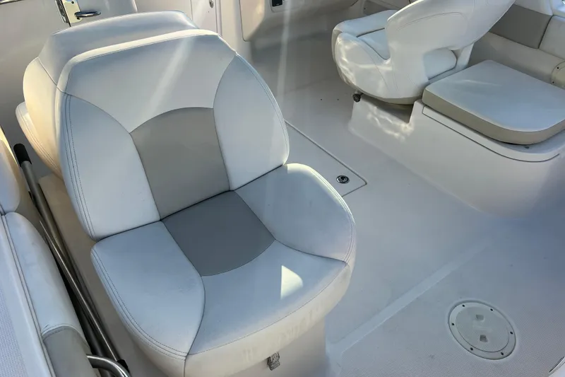 Slide: The Image of 2015 Robalo R227 Dual Console boat interior with white seating and clean deck. - 54