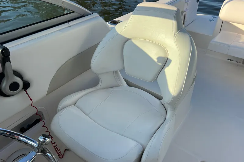 Slide: The Image of 2015 Robalo R227 Dual Console boat seat, white leather, near steering wheel. - 58