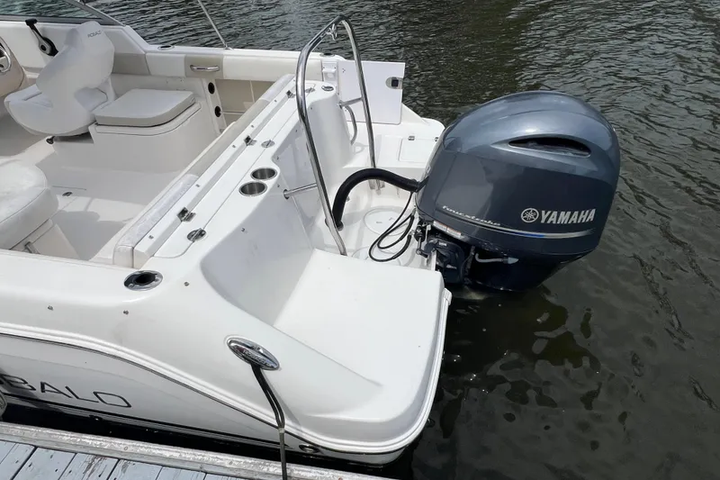 Slide: The Image of 2015 Robalo R227 Dual Console boat with Yamaha outboard engine on water. - 6