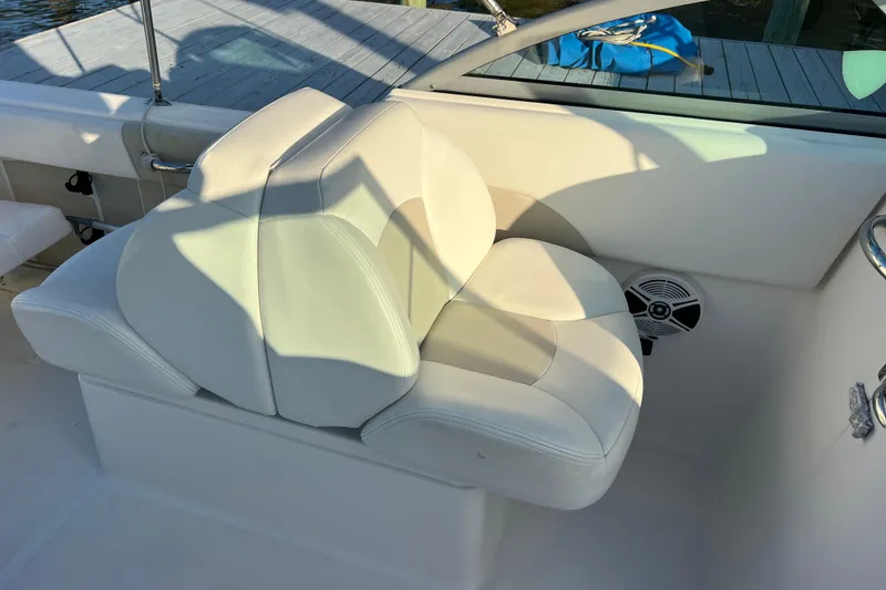 Slide: The Image of 2015 Robalo R227 Dual Console boat seat with white upholstery and speaker. - 60