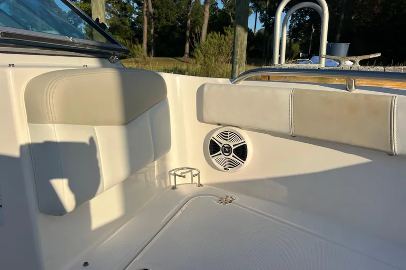 Slide: The Image of 2015 Robalo R227 Dual Console interior with speaker and cushioned seating. - 61