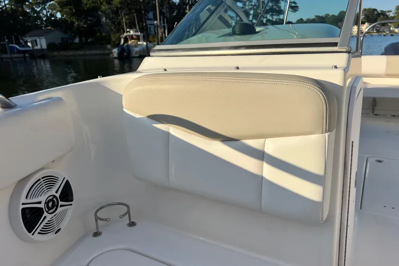 Slide: The Image of 2015 Robalo R227 Dual Console boat interior with speaker and cup holder. - 62