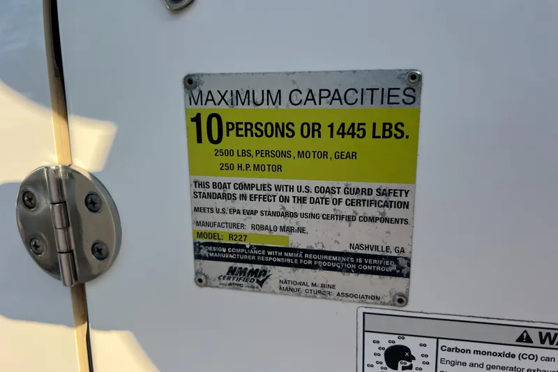 Slide: The Image of 2015 Robalo R227 Dual Console capacity label, 10 persons or 1445 lbs, 250 HP motor. - 63