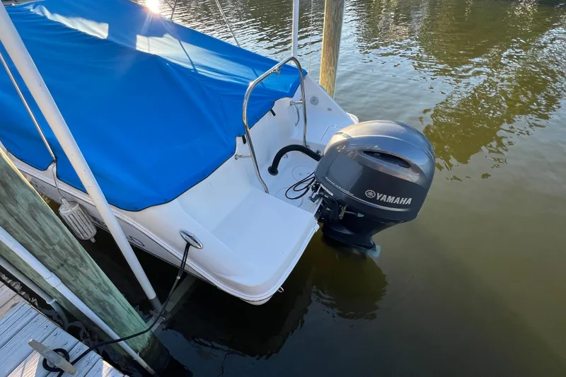 Slide: The Image of 2015 Robalo R227 Dual Console with Yamaha outboard, docked with blue cover. - 68