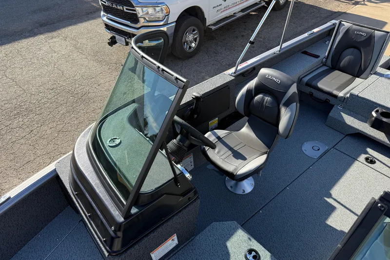 Slide: The Image of 2026 Lund 1775 Impact XS Sport boat interior with seating and steering console. - 15