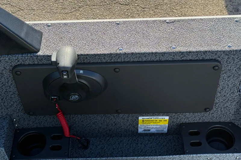 Slide: The Image of Control panel of 2026 Lund 1775 Impact XS Sport boat with throttle and cup holders. - 18