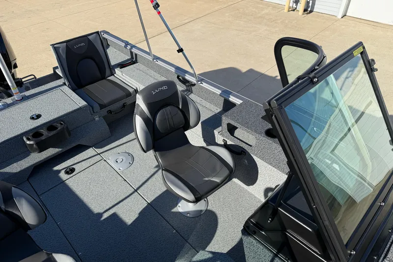 Slide: The Image of 2026 Lund 1775 Impact XS Sport boat interior with seating and windshield. - 19