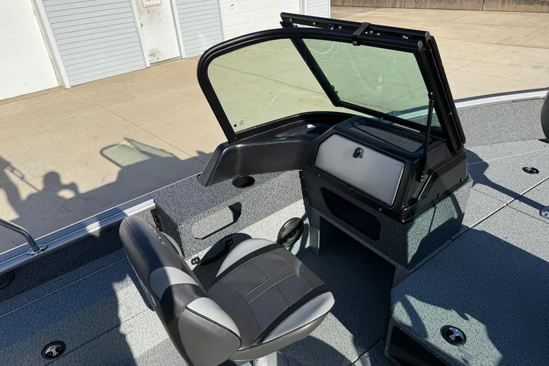 Slide: The Image of 2026 Lund 1775 Impact XS Sport boat interior with seating and console. - 20