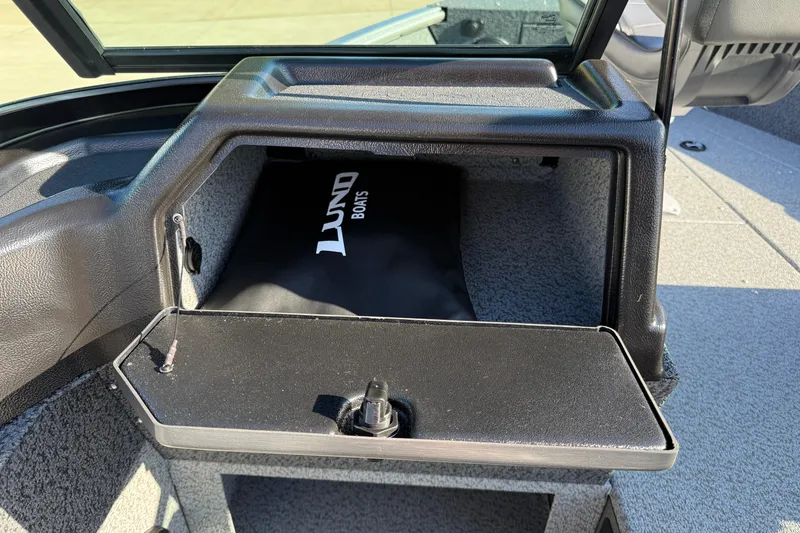 Slide: The Image of 2026 Lund 1775 Impact XS Sport boat storage compartment with open lid. - 22