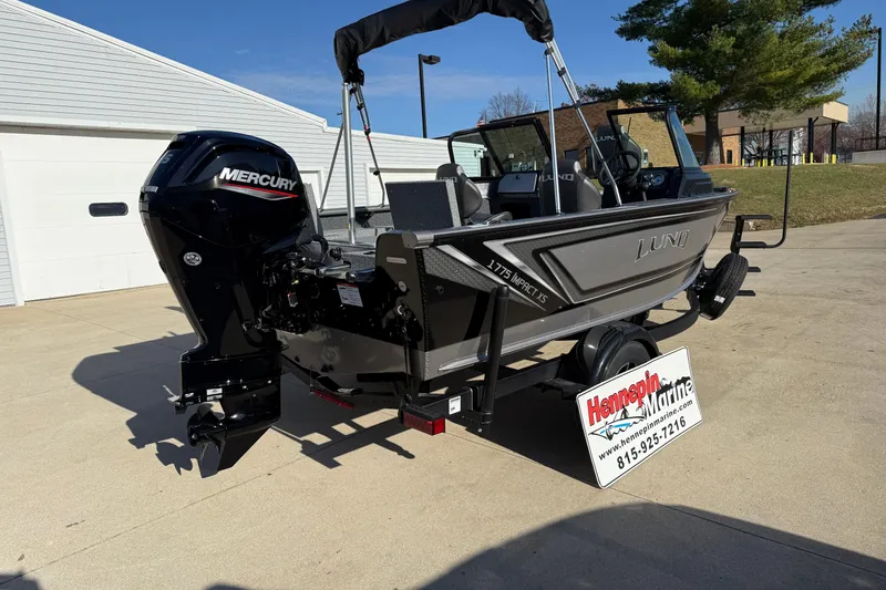 Slide: The Image of 2026 Lund 1775 Impact XS Sport boat with Mercury engine on trailer, outdoor display. - 8
