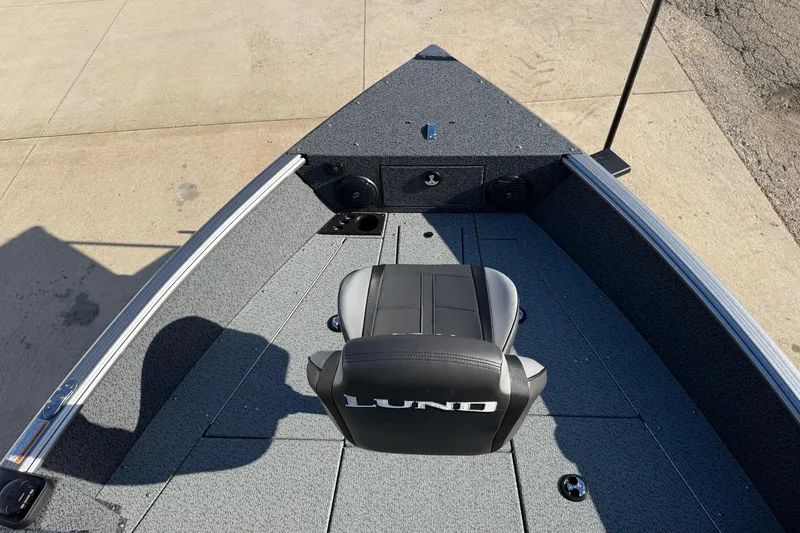 Slide: The Image of 2026 Lund 1775 Impact XS Sport boat interior with a single seat and spacious deck. - 9