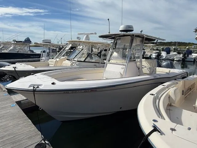 Slide: The Image of 2005 Grady-White Chase 273 boat docked at a marina under a cloudy sky. - 1