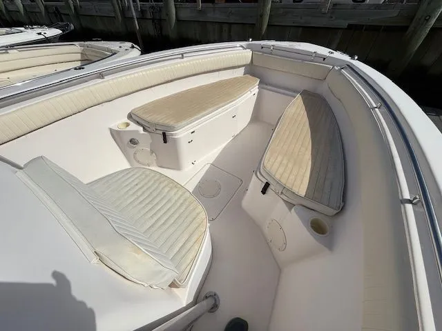 Slide: The Image of 2005 Grady-White Chase 273 boat interior with cushioned seating and storage compartments. - 13