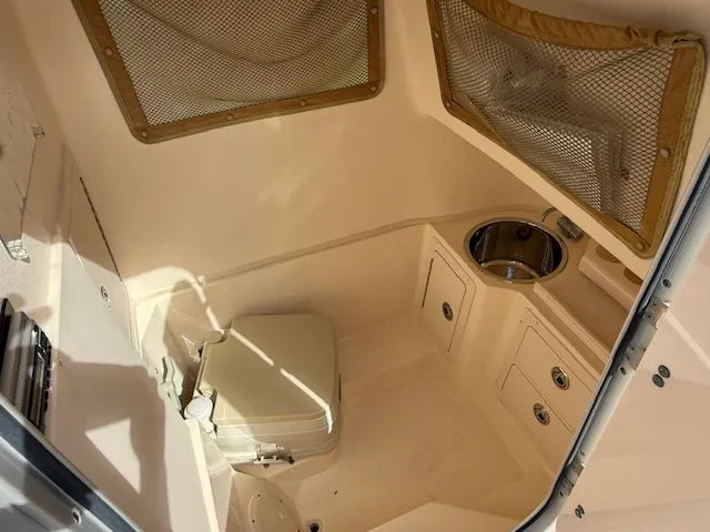 Slide: The Image of 2005 Grady-White Chase 273 boat interior with compact toilet and sink. - 14