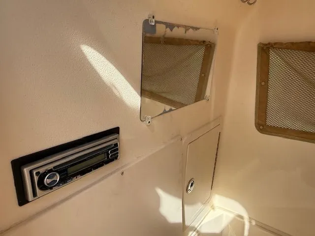 Slide: The Image of Interior of 2005 Grady-White Chase 273 boat with radio and storage compartments. - 16