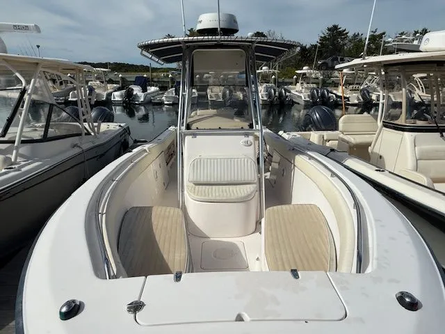 Slide: The Image of 2005 Grady-White Chase 273 boat docked in a marina, showcasing spacious deck and seating. - 2