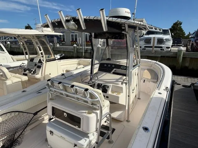 Slide: The Image of 2005 Grady-White Chase 273 boat docked, featuring center console and fishing rod holders. - 4