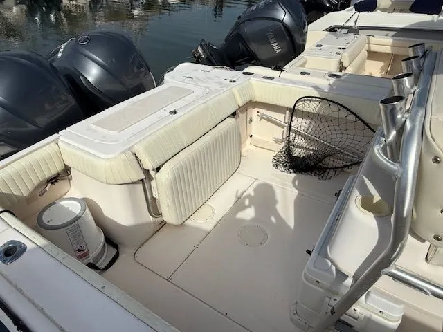 Slide: The Image of 2005 Grady-White Chase 273 boat interior with seating, fishing net, and outboard motors. - 5