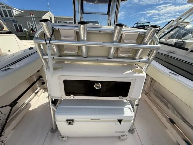 Slide: The Image of 2005 Grady-White Chase 273 boat interior with rod holders and storage compartments. - 7