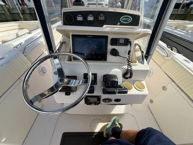 Slide: The Image of 2005 Grady-White Chase 273 boat console with steering wheel and navigation equipment. - 9