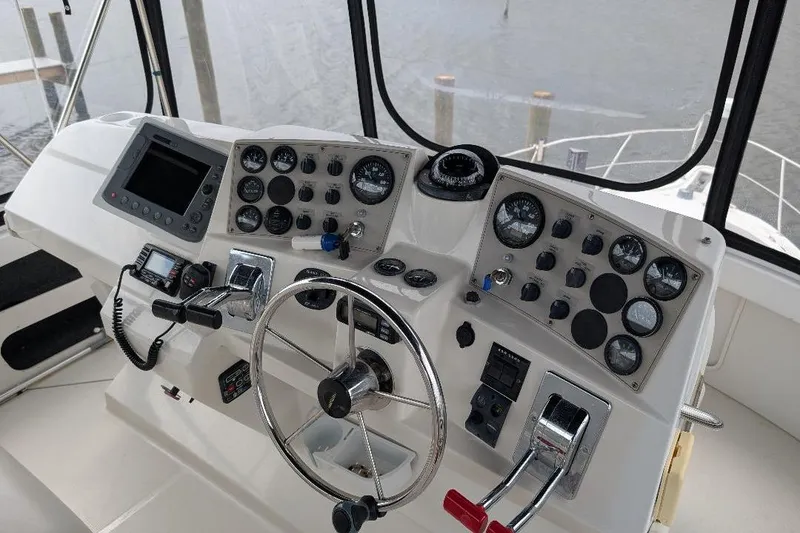 Slide: The Image of Helm of 2003 Carver 356 Motor Yacht with steering wheel and control panel. - 13