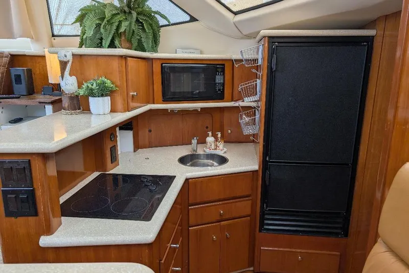 Slide: The Image of Luxurious kitchen interior of 2003 Carver 356 Motor Yacht with modern amenities. - 21